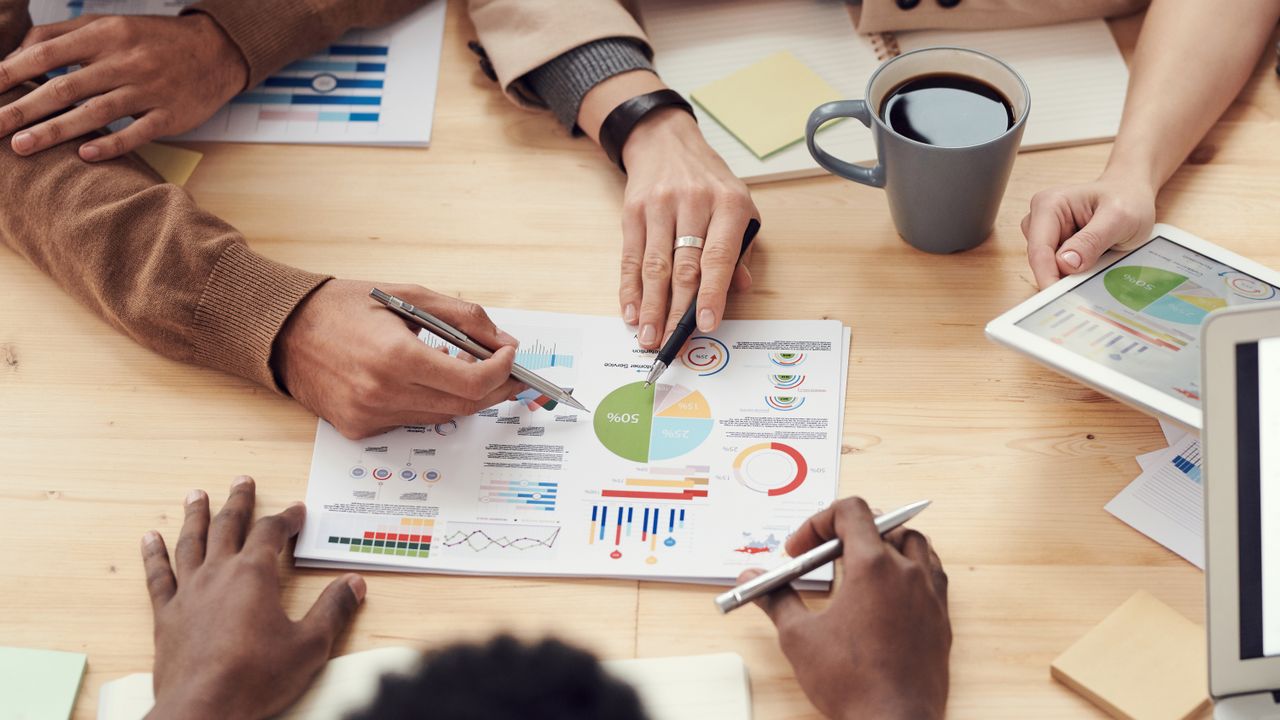 Small-business team reviewing figures at a shared desk